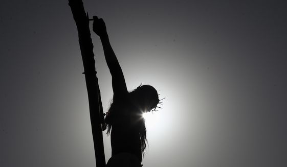 A Christian enacts the crucifixion of Jesus Christ to mark Good Friday in Hyderabad, India, Friday, April 2, 2021. Christians all over the world attend mock crucifixions and passion plays that mark the day Jesus was crucified, known to Christians as Good Friday. (AP Photo/Mahesh Kumar A.)
