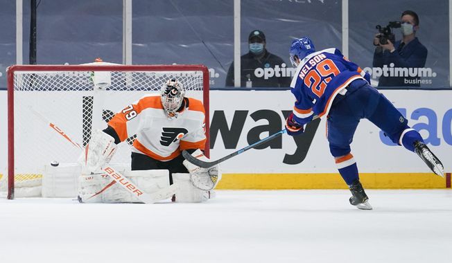 New York Islanders&#x27; Brock Nelson (29) shoots the puck past Philadelphia Flyers goaltender Carter Hart (79) for the game winning goal during the shootout period of an NHL hockey game Thursday, April 8, 2021, in Uniondale, N.Y. The Islanders won 3-2. (AP Photo/Frank Franklin II)
