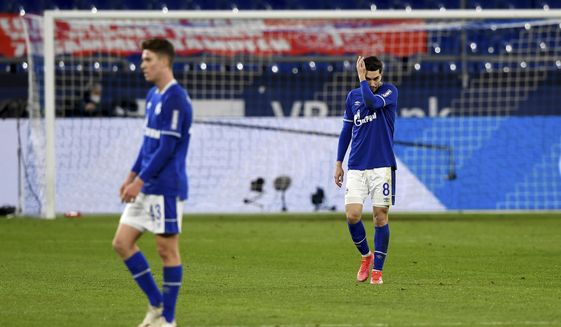Schalke&#39;s Matthew Hoppe, left, and Suat Serdar react on the pitch during the German Bundesliga soccer match between FC Schalke 04 and Borussia Moenchengladbach at Veltins Arena, Gelsenkirchen, Germany, Saturday March 20, 2021. After loosing the match 0-3 Schalke is last in the Bundesliga with little to no hope of survival. (Guido Kirchner/dpa via AP)