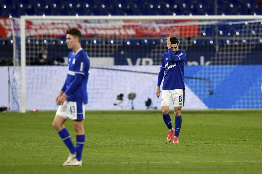 Schalke&#39;s Matthew Hoppe, left, and Suat Serdar react on the pitch during the German Bundesliga soccer match between FC Schalke 04 and Borussia Moenchengladbach at Veltins Arena, Gelsenkirchen, Germany, Saturday March 20, 2021. After loosing the match 0-3 Schalke is last in the Bundesliga with little to no hope of survival. (Guido Kirchner/dpa via AP)