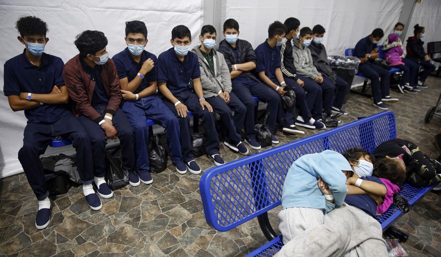 In this March 30, 2021, file photo, young unaccompanied migrants wait for their turn at the secondary processing station inside the U.S. Customs and Border Protection facility, the main detention center for unaccompanied children in the Rio Grande Valley, in Donna, Texas. U.S. authorities say they picked up nearly 19,000 children traveling alone across the Mexican border in March. It&#x27;s the largest monthly number ever recorded and a major test for President Joe Biden as he reverses many of his predecessor&#x27;s hardline immigration tactics. (AP Photo/Dario Lopez-Mills, Pool, File)