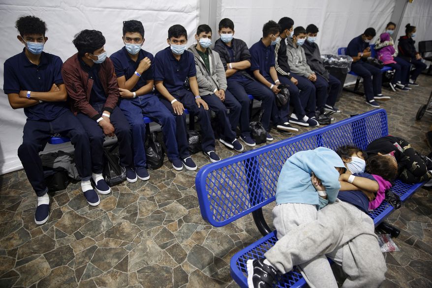 In this March 30, 2021, file photo, young unaccompanied migrants wait for their turn at the secondary processing station inside the U.S. Customs and Border Protection facility, the main detention center for unaccompanied children in the Rio Grande Valley, in Donna, Texas. U.S. authorities say they picked up nearly 19,000 children traveling alone across the Mexican border in March. It&#39;s the largest monthly number ever recorded and a major test for President Joe Biden as he reverses many of his predecessor&#39;s hardline immigration tactics. (AP Photo/Dario Lopez-Mills, Pool, File)