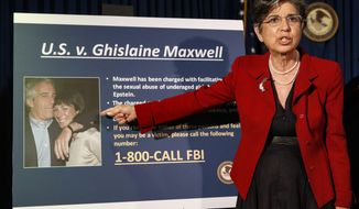 FILE- In this July 2, 2020 file photo, Audrey Strauss, Acting United States Attorney for the Southern District of New York, points to a photo of Jeffrey Epstein and his ex-girlfriend Ghislaine Maxwell. Sex trafficking charges were added Monday, March 29, 2021 to the indictment against financier Jeffrey Epstein’s ex-girlfriend as prosecutors alleged that she groomed a 14-year-old girl to recruit other young females in the early 2000s to provide “sexualized massages” to Epstein in return for cash. (AP Photo/John Minchillo, File)