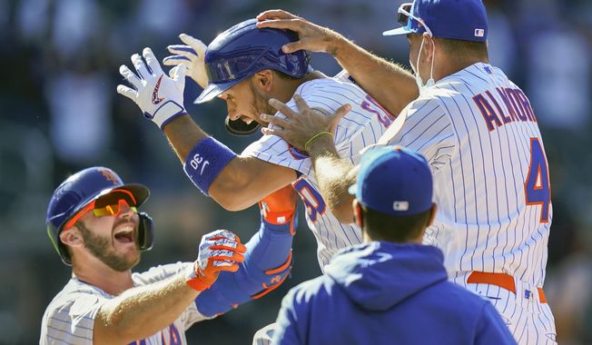 New York Mets&#x27; Michael Conforto (30) celebrates after being hit by a pitch and scoring the winning run on loaded bases during the ninth inning of a baseball game against the Miami Marlins, Thursday, April 8, 2021, in New York. (AP Photo/John Minchillo)