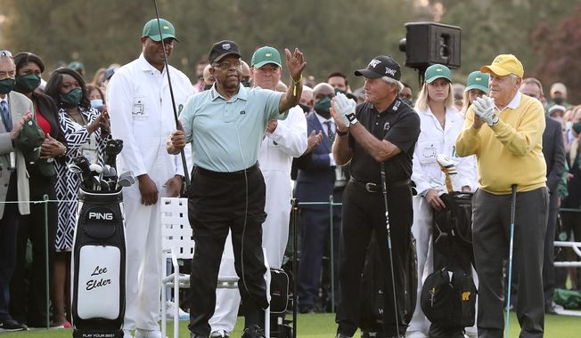 Honorary starter Lee Elder, left, gestures as he is introduced and applauded by honorary starters Gary Player and Jack Nicklaus, right, before the ceremonial tee shots to begin the Masters golf tournament at Augusta National Golf Club in Augusta, Ga., Thursday, April 8, 2021. (Curtis Compton/Atlanta Journal-Constitution via AP)