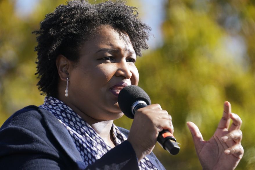 FILE - In this Nov. 2, 2020, file photo Stacey Abrams speaks to Biden supporters as they wait for former President Barack Obama to arrive and speak at a rally as he campaigns for Democratic presidential candidate former Vice President Joe Biden at Turner Field in Atlanta. In a new interview with The Associated Press, voting rights advocate Abrams discussed a new state law that tightens some Georgia voting rules after Democrats carried the state in the 2020 elections. (AP Photo/Brynn Anderson, File)