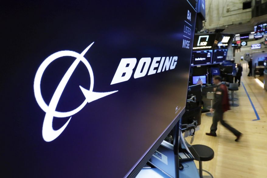 FILE - In this March 11, 2019 file photo, the Boeing logo appears above a trading post on the floor of the New York Stock Exchange before the opening bell.  Boeing is suing a subcontractor it hired to work on new Air Force One planes that will carry the president of the United States. Boeing says a subcontractor on in Fort Worth, Texas, missed deadlines for work on the planes.  (AP Photo/Richard Drew, File)
