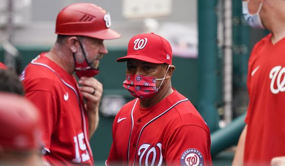 Washington Nationals manager Dave Martinez, center, walks in the dugout during the sixth inning of the second baseball game of the team&#39;s doubleheader against the Atlanta Braves at Nationals Park, Wednesday, April 7, 2021, in Washington. The Braves won 2-0. (AP Photo/Alex Brandon) **FILE**