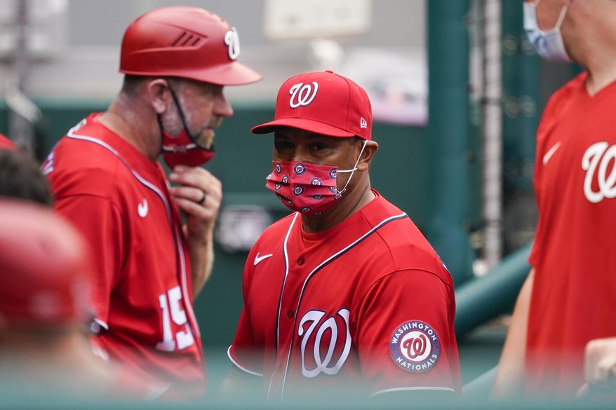Washington Nationals manager Dave Martinez, center, walks in the dugout during the sixth inning of the second baseball game of the team&#39;s doubleheader against the Atlanta Braves at Nationals Park, Wednesday, April 7, 2021, in Washington. The Braves won 2-0. (AP Photo/Alex Brandon) **FILE**