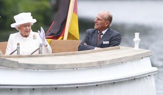 FILE - In this Wednesday June 24, 2015 file photo, Britain&#39;s Queen Elizabeth II and Prince Philip travel by boat on the Spree river in Berlin, Germany. Buckingham Palace officials say Prince Philip, the husband of Queen Elizabeth II, has died, it was announced on Friday, April 9, 2021. He was 99. Philip spent a month in hospital earlier this year before being released on March 16 to return to Windsor Castle. Philip, also known as the Duke of Edinburgh, married Elizabeth in 1947 and was the longest-serving consort in British history.  (Hannibal Hanschke/Pool Photo via AP, File)