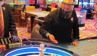 A dealer conducts a game of roulette at the Hard Rock Casino in Atlantic City N.J. on July 2, 2020, the first day the casino was allowed to reopen during the coronavirus pandemic. Figures released on April 9, 2021, show Atlantic City&#39;s nine casinos collectively saw their gross operating profits decline by more than 80% in 2020. (AP Photo/Wayne Parry)