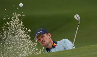 Justin Rose, of England, hits out of a bunker on the seventh hole during the second round of the Masters golf tournament on Friday, April 9, 2021, in Augusta, Ga. (AP Photo/Gregory Bull)