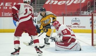 Detroit Red Wings goaltender Thomas Greiss (29) stops a Nashville Predators right wing Mathieu Olivier (25) shot as Filip Hronek (17) defends in the first period of an NHL hockey game Tuesday, April 6, 2021, in Detroit. (AP Photo/Paul Sancya)