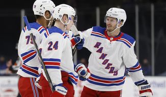 New York Rangers&#x27; K&#x27;Andre Miller (79) is congratulated by teammates Jacob Trouba (8) and Kaapo Kakko (24), of Finland, after scoring against the New York Islanders during the third period of an NHL hockey game Friday, April 9, 2021, in Uniondale, N.Y. (AP Photo/Jason DeCrow)