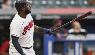 Cleveland Indians&#39; Franmil Reyes watches his two-run home run off Detroit Tigers starting pitcher Derek Holland during the first inning of a baseball game Friday, April 9, 2021, in Cleveland. (AP Photo/Tony Dejak)