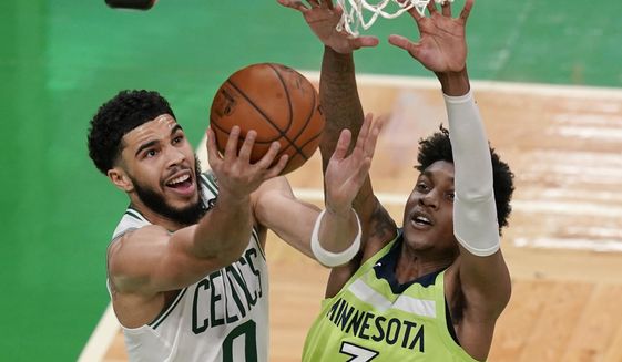 Boston Celtics forward Jayson Tatum (0) goes to the basket against Minnesota Timberwolves forward Jaden McDaniels (3) during the second quarter of an NBA basketball game Friday, April 9, 2021, in Boston. (AP Photo/Elise Amendola)
