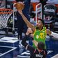 Utah Jazz guard Donovan Mitchell (45) lays the ball up while guarded by Portland Trail Blazers center Jusuf Nurkic (27) during the first half of an NBA basketball game Thursday, April 8, 2021, in Salt Lake City. (AP Photo/Isaac Hale)