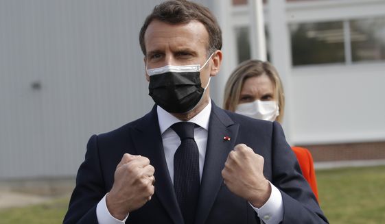 French President Emmanuel Macron reacts after visiting the Delpharm plant in Saint-Remy-sur-Avre, west of Paris, Friday, April 9, 2021 in Paris. The Delpharm plant started bottling Pfizer vaccines this week as France tries to make its mark on global vaccine production, and speed up vaccinations of French people amid a new virus surge. (AP Photo/Christophe Ena, Pool)