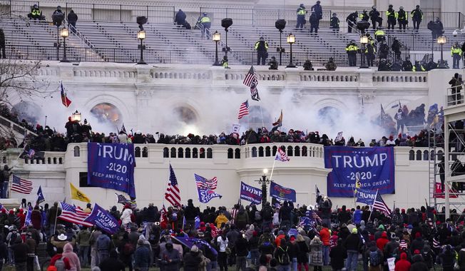 In this Wednesday, Jan. 6, 2021, file photo, violent rioters storm the Capitol, in Washington. (AP Photo/John Minchillo, File)