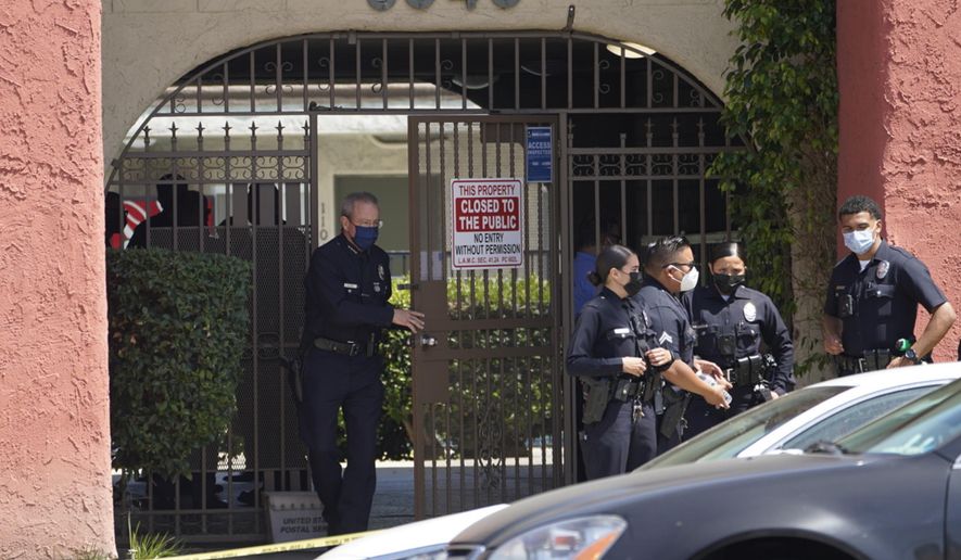Los Angeles Police Chief Michel Moore exits an apartment complex as police investigate in Reseda, Calif., Saturday, April 10, 2021. The mother of three children — all under the age of 5 — found slain inside a Los Angeles apartment Saturday morning has been arrested, police said. (AP Photo/Damian Dovarganes)