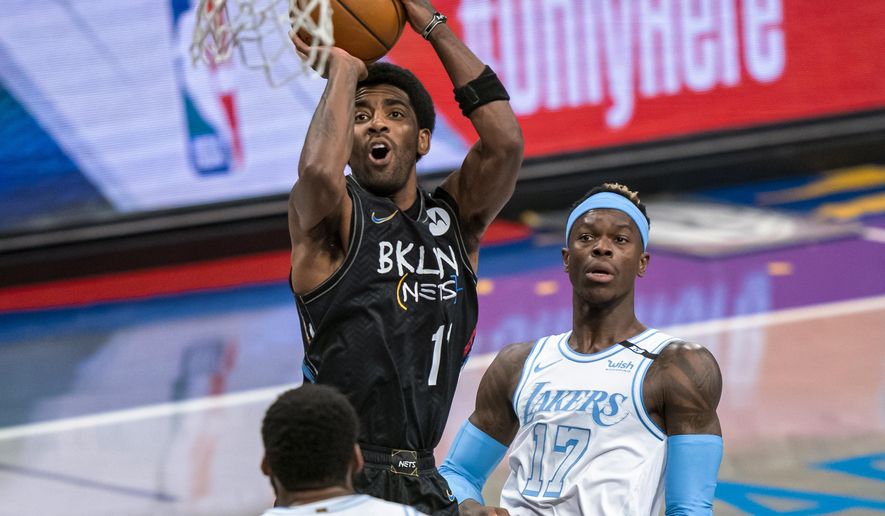 Brooklyn Nets guard Kyrie Irving shoots over Los Angeles Lakers center Andre Drummond and guard Dennis Schroeder (17) during the first half of an NBA basketball game, Saturday, April 10, 2021, in New York (AP Photo/Corey Sipkin).