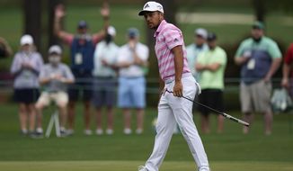 Xander Schauffele watches as his ball goes in for an eagle on the 15th hole during the third round of the Masters golf tournament on Saturday, April 10, 2021, in Augusta, Ga. (AP Photo/Matt Slocum)