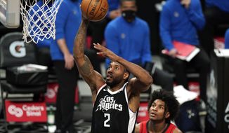 Los Angeles Clippers forward Kawhi Leonard, left, shoots as Houston Rockets guard Kevin Porter Jr. watches during the first half of an NBA basketball game Friday, April 9, 2021, in Los Angeles. (AP Photo/Mark J. Terrill)