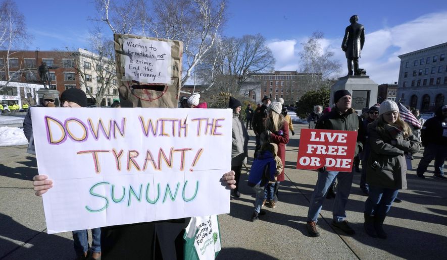 FILE - In this Thursday, Jan. 7, 2021 file photo, people protest outside the Statehouse in Concord, N.H., as Gov. Chris Sununu is inaugurated at noon for his third term as governor. A measure that recently passed New Hampshire's Republican-led House would prohibit governors from indefinitely renewing emergency declarations, as Sununu has done every 21 days for the past year. It would halt emergency orders after 30 days unless renewed by lawmakers. (AP Photo/Charles Krupa)