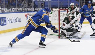 St. Louis Blues&#39; Ryan O&#39;Reilly (90) scores the winning goal past Minnesota Wild&#39;s Cam Talbot (33) during overtime of an NHL hockey game on Saturday, April 10, 2021, in St. Louis. (AP Photo/Joe Puetz)