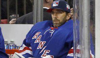 FILE - Then-New York Rangers goaltender Henrik Lundqvist looks on from the bench during an NHL hockey game against the Buffalo Sabres in New York, in this Friday, Feb. 7, 2020, file photo. Henrik Lundqvist is abandoning a long-shot attempt to return from open-heart surgery in time to play for the Washington Capitals this season after a checkup last week showed some inflammation. Lundqvist tweeted Sunday, April 11, 2021, that the inflammation around his heart requires a few months of rest and recovery. The 39-year-old goaltender had set the goal for himself of trying to join the Capitals before the end of the season. (AP Photo/Jim McIsaac, File)