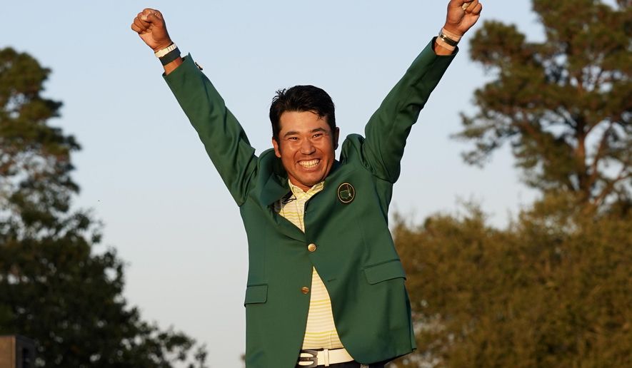 Hideki Matsuyama, of Japan, celebrates after putting on the champion&#39;s green jacket after winning the Masters golf tournament on Sunday, April 11, 2021, in Augusta, Ga. (AP Photo/Gregory Bull)
