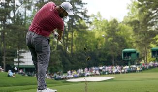 Jon Rahm, of Spain, hits his tee shot on the 16th hole during the final round of the Masters golf tournament on Sunday, April 11, 2021, in Augusta, Ga. (AP Photo/David J. Phillip)