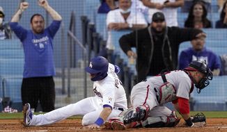 Los Angeles Dodgers&#39; AJ Pollock, left, scores on a single by Zach McKinstry as Washington Nationals catcher Yan Gomes can&#39;t hold on to the throw during the second inning of a baseball game Saturday, April 10, 2021, in Los Angeles. (AP Photo/Mark J. Terrill)