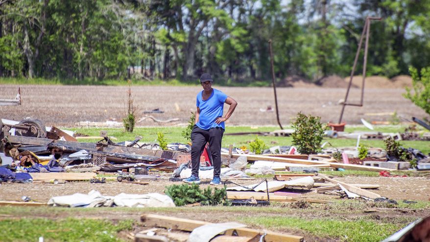 A resident looks at the damage after a tornado ripped through Palmetto, La., Saturday, April 10, 2021. (Andre Broussard/The Daily Advertiser via AP)