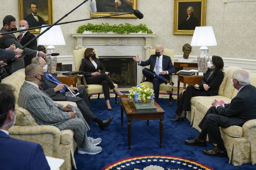 President Joe Biden and Vice President Kamala Harris meet with lawmakers to discuss the American Jobs Plan in the Oval Office of the White House, Monday, April 12, 2021, in Washington. (AP Photo/Patrick Semansky)