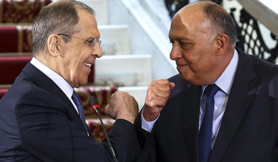 In this photo released by Russian Foreign Ministry Press Service, Egyptian Foreign Minister Sameh Shukry, right, and Russia&#39;s Foreign Minister Sergei Lavrov greet each other after a joint news conference following their talks in Cairo, Egypt, Monday, April 12, 2021. (Russian Foreign Ministry Press Service via AP)