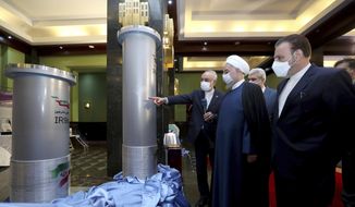 In this April 10, 2021, file photo released by the official website of the office of the Iranian presidency, Iranian President Hassan Rouhani, second from right, listens to the head of the Atomic Energy Organization of Iran Ali Akbar Salehi while visiting an exhibition of Iran&#39;s new nuclear achievements in Tehran, Iran. Iran&#39;s nuclear program has been targeted by diplomatic efforts and sabotage attacks over the last decade, with the latest incident striking its underground Natanz facility. The attack Sunday, April 11, 2021 at Natanz comes as world powers try to negotiate a return by Iran and the U.S. to Tehran&#39;s atomic accord. (Iranian Presidency Office via AP) **FILE**