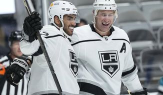 Los Angeles Kings left wing Andreas Athanasiou (22) celebrates with center Jeff Carter (77) after scoring a gaol against the San Jose Sharks during the second period of an NHL hockey game Saturday, April 10, 2021, in San Jose, Calif. (AP Photo/Tony Avelar)