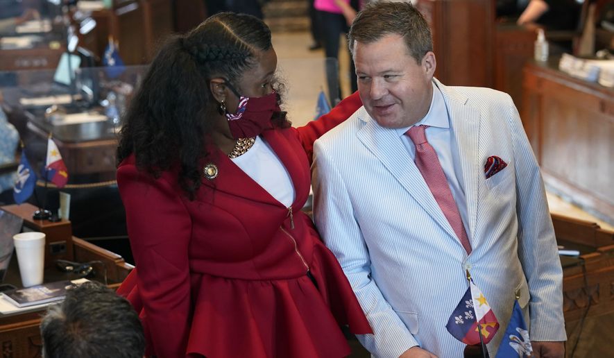 Sen. Katrina Jackson, D-Monroe, talks with Stuart Bishop, R-Lafayette, chairman of the House Ways and Means Committee, during opening day of the Louisiana legislative session in Baton Rouge, La., Monday, April 12, 2021. (AP Photo/Gerald Herbert)