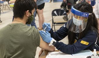 In this file photo, a Kent State University student gets his Johnson &amp; Johnson COVID-19 vaccination from Kent State nursing student Allie Rodriguez in Kent, Ohio, Thursday, April 8, 2021. On Friday, June 25, the FDA released a warning noting increased risk of heart inflammation for patients receiving either the Pfizer or Moderna vaccines, following a review of data showing reported cases of inflammation in some young patients, often in the week after receiving the second does. Johnson &amp; Johnson&#x27;s one-shot vaccine is not included in the warning. (AP Photo/Phil Long)