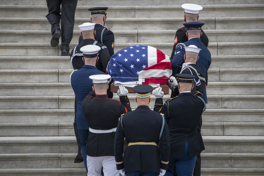 The flag-draped casket of U.S. Capitol Police officer William &quot;Billy&quot; Evans, arrives to lie in honor at the U.S. Capitol, Tuesday, April 13, 2021 at the U.S. Capitol in Washington. (Shawn Thew/Pool via AP)