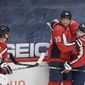 Washington Capitals right wing Anthony Mantha (39) celebrates his goal with right wing T.J. Oshie (77) and defenseman Dmitry Orlov (9) during the second period of an NHL hockey game against the Philadelphia Flyers, Tuesday, April 13, 2021, in Washington. (AP Photo/Nick Wass)