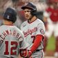 Washington Nationals&#39; Trea Turner (7) is congratulated by teammate Kyle Schwarber (12) after scoring during the third inning of a baseball game against the St. Louis Cardinals Tuesday, April 13, 2021, in St. Louis. (AP Photo/Jeff Roberson)