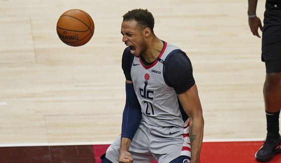 Washington Wizards center Daniel Gafford (21) reacts after making a dunk against the Utah Jazz in the second half during an NBA basketball game Monday, April 12, 2021, in Salt Lake City. (AP Photo/Rick Bowmer) **FILE**