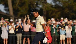 Hideki Matsuyama, of Japan, waves after winning the Masters golf tournament on Sunday, April 11, 2021, in Augusta, Ga. (AP Photo/Matt Slocum)