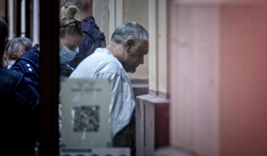 Mohinder Singh, right, arrives at the Supreme Court of Victoria for his sentence hearing in Melbourne, Wednesday, April 14, 2021. Singh, a truck driver, has been imprisoned 22 years for hitting and killing four police officers on an Australian freeway. (Luis Ascui/AAP Image via AP)