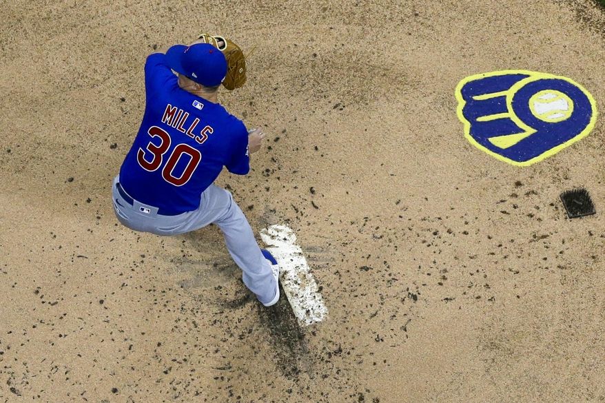 Chicago Cubs starting pitcher Alec Mills throws during the first inning of a baseball game against the Milwaukee Brewers Tuesday, April 13, 2021, in Milwaukee. (AP Photo/Morry Gash)