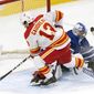 Calgary Flames&#39; Johnny Gaudreau (13) scores the game winning goal on Toronto Maple Leafs goaltender David Rittich (33) in overtime of an NHL hockey game Tuesday, April 13, 2021 in Toronto. (Frank Gunn/Canadian Press via AP)