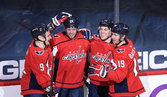 Washington Capitals right wing Anthony Mantha (39) celebrates his goal with defenseman Dmitry Orlov (9), right wing T.J. Oshie (77) and center Nicklas Backstrom (19) during the second period of an NHL hockey game against the Philadelphia Flyers, Tuesday, April 13, 2021, in Washington. (AP Photo/Nick Wass)