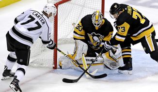 FILE - Los Angeles Kings&#39; Jeff Carter (77) can&#39;t get his stick on a rebound in front of Pittsburgh Penguins goaltender Matt Murray (30) with Jack Johnson (73) defending during the first period of an NHL hockey game in Pittsburgh, in this  Saturday, Dec. 15, 2018, file photo. All divisional play during this shortened NHL season gives an added perk to most of the players traded at the deadline: They&#39;ll get to face different teams. Jeff Carter is plenty used to Eastern opponents after starting with the Flyers but will be glad to play in front of some home fans with the Penguins. (AP Photo/Gene J. Puskar, File)